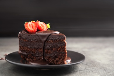 Photo of Delicious fresh chocolate cake with strawberry on grey table