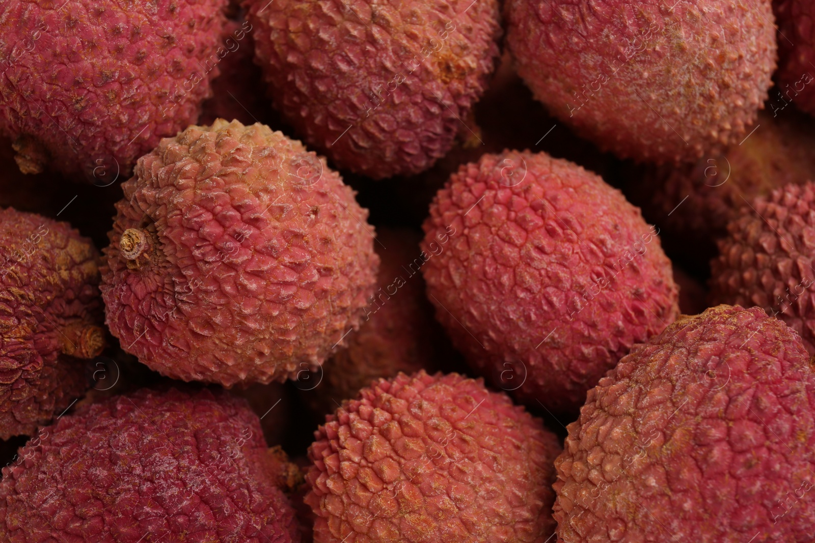 Photo of Pile of fresh ripe lychees as background, top view