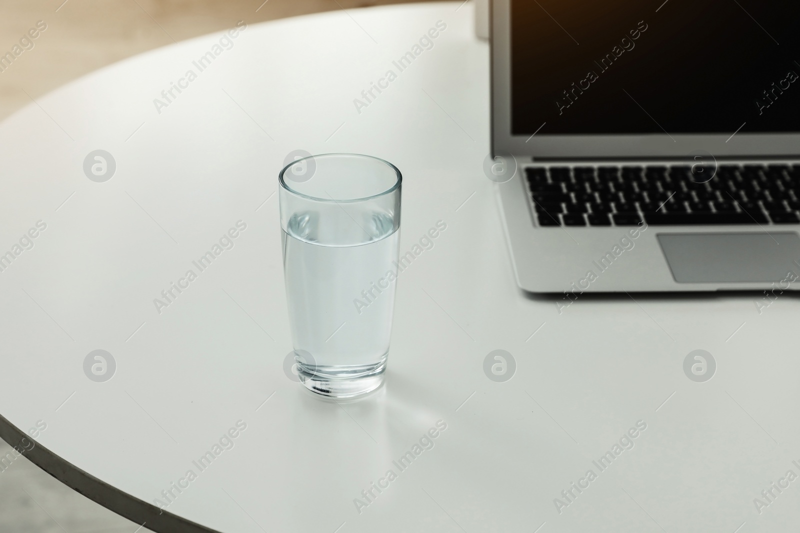 Photo of Glass of fresh water on table indoors. Space for text