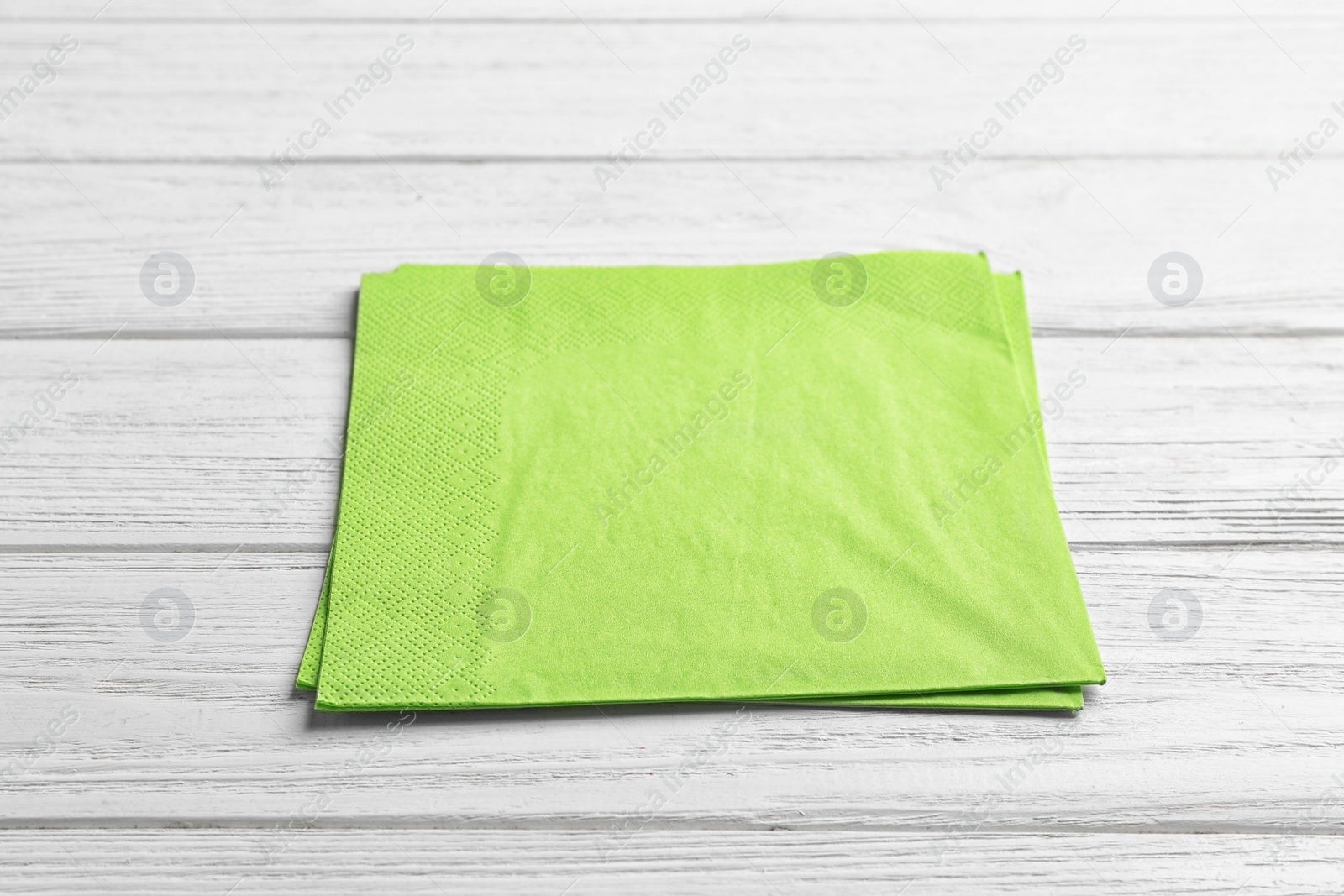 Photo of Clean napkins on wooden background. Personal hygiene