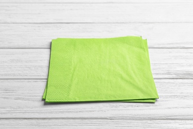 Photo of Clean napkins on wooden background. Personal hygiene