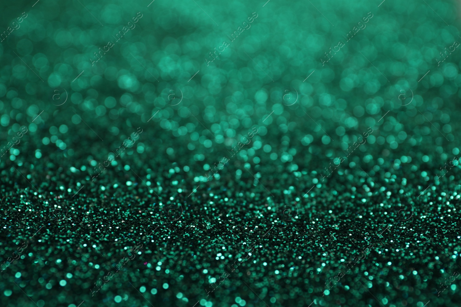 Photo of Shiny green glitter as background. Bokeh effect