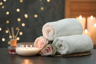 Photo of Composition with different spa products and rose flowers on grey table