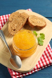 Fresh pike caviar in glass jar, bread and parsley on blue wooden table