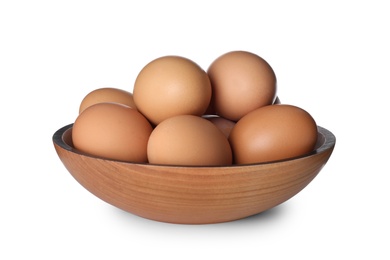 Wooden bowl with chicken eggs isolated on white