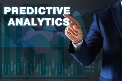 Image of Concept of predictive analytics. Businessman pointing at phrase on virtual screen, closeup