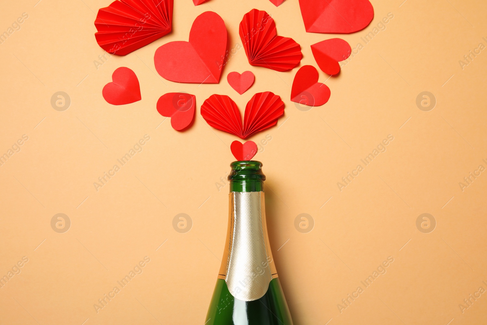 Photo of Creative flat lay composition with bottle of champagne on color background