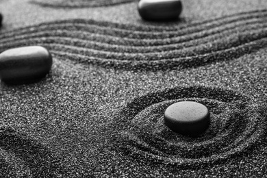 Black sand with stones and beautiful pattern. Zen concept