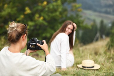 Photo of Professional photographer working with model in nature