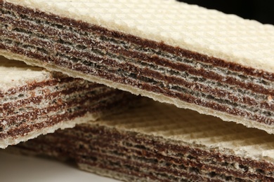 Photo of Delicious crispy wafers with chocolate filling as background, closeup view