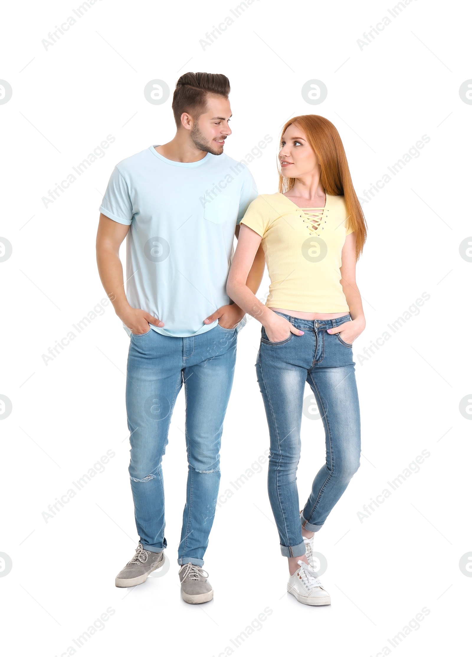 Photo of Young couple in stylish jeans on white background