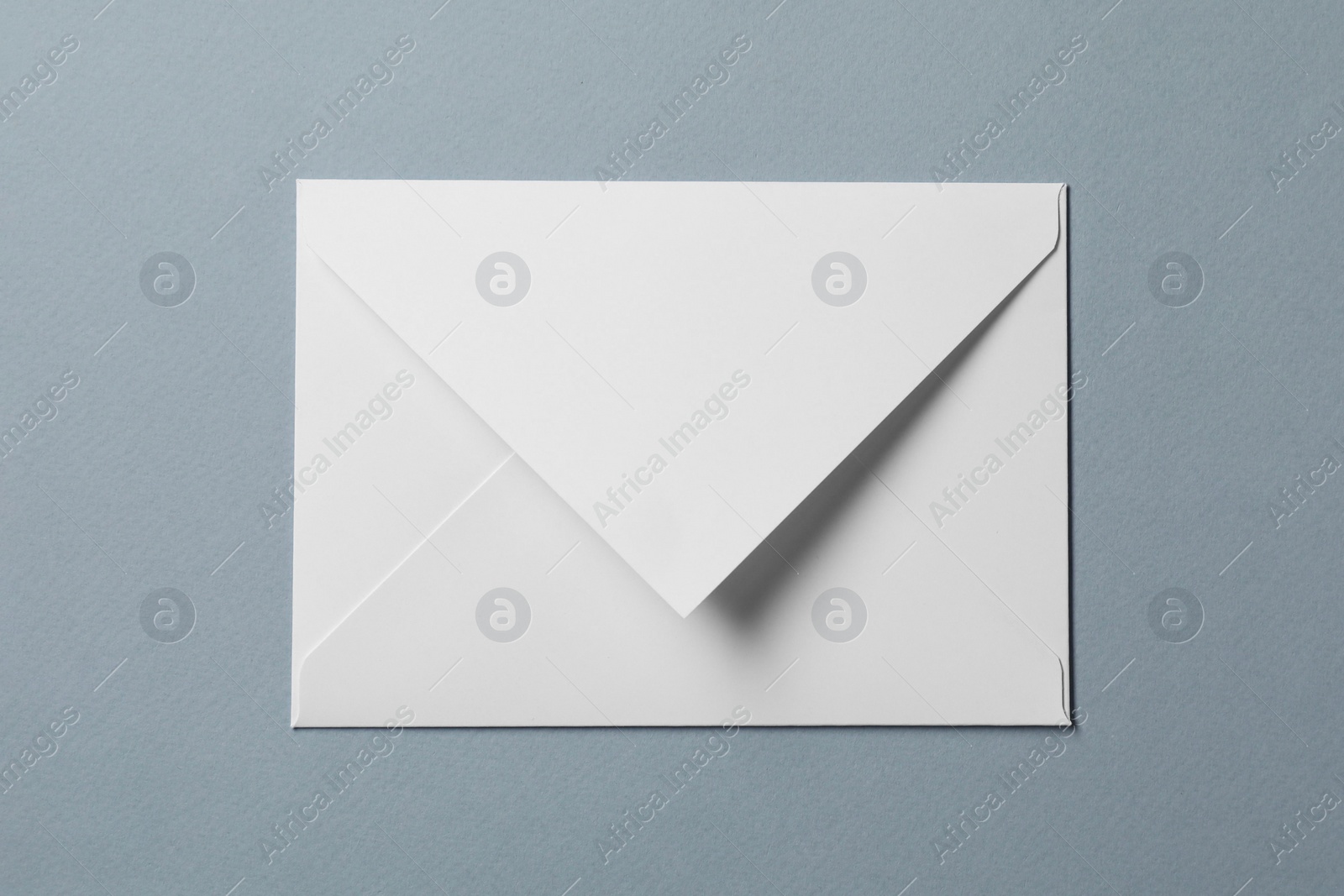 Photo of Letter envelope on grey background, top view