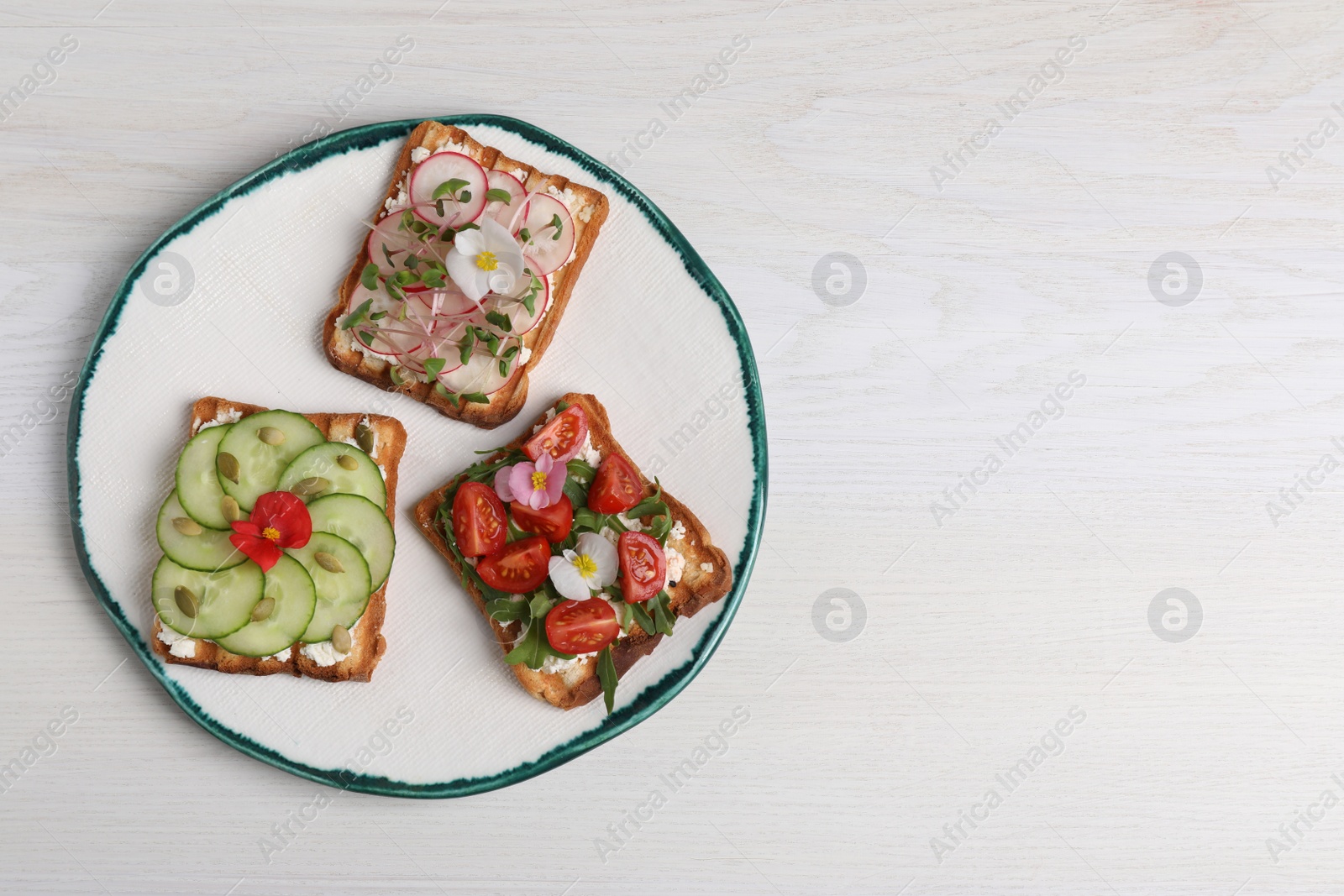 Photo of Different delicious sandwiches on white wooden table, top view. Space for text