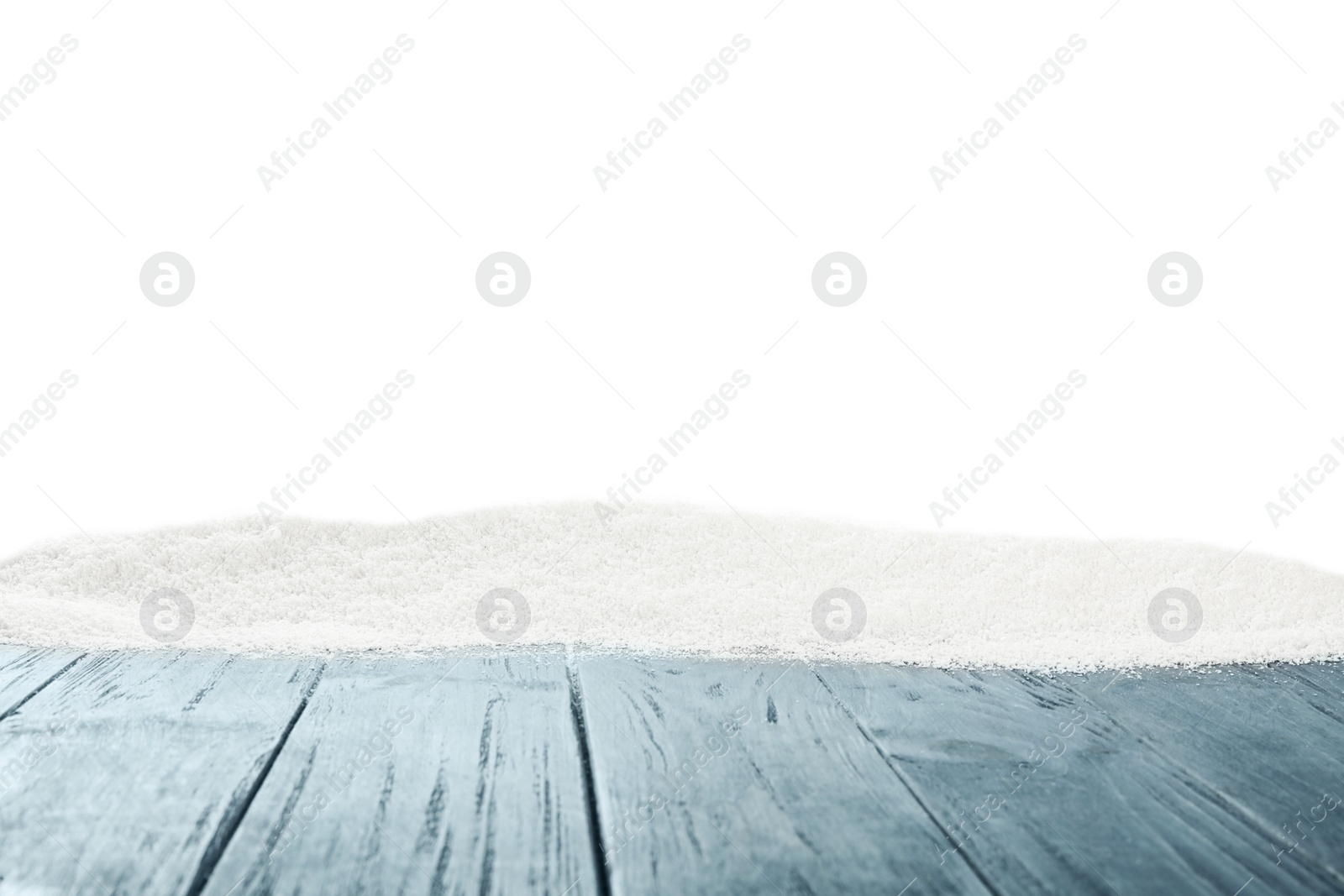 Photo of Artificial snow on light grey wooden table against white background. Christmas decor