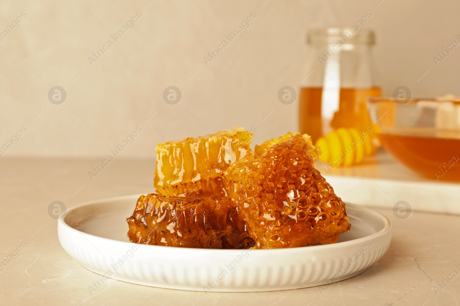 Photo of Plate with fresh sweet honeycombs on table