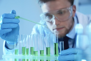 Photo of Male scientist working with sample in chemistry laboratory