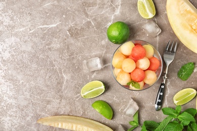 Photo of Flat lay composition with melon and watermelon balls on brown marble table. Space for text