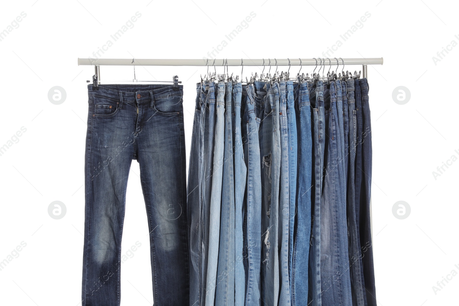 Photo of Rack with different jeans isolated on white