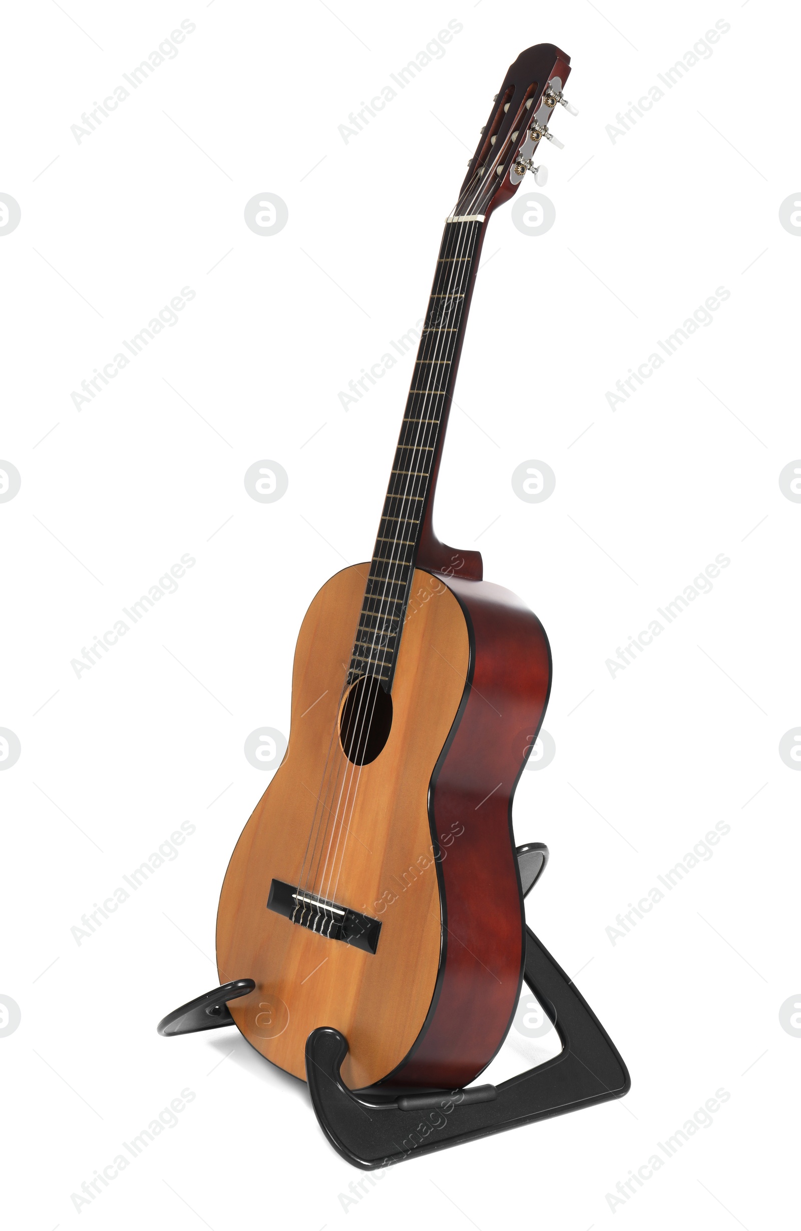 Photo of Acoustic guitar on stand against white background