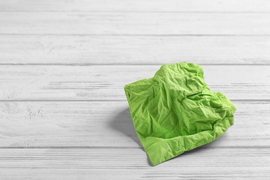 Crumpled napkin on wooden background, space for text. Personal hygiene