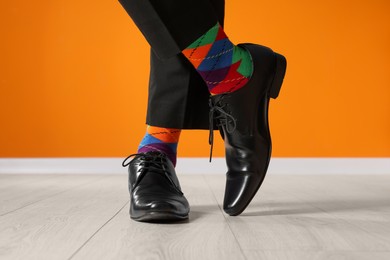 Man wearing stylish shoes and colorful socks indoors, closeup