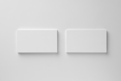 Photo of Blank business cards on white background, top view. Mockup for design