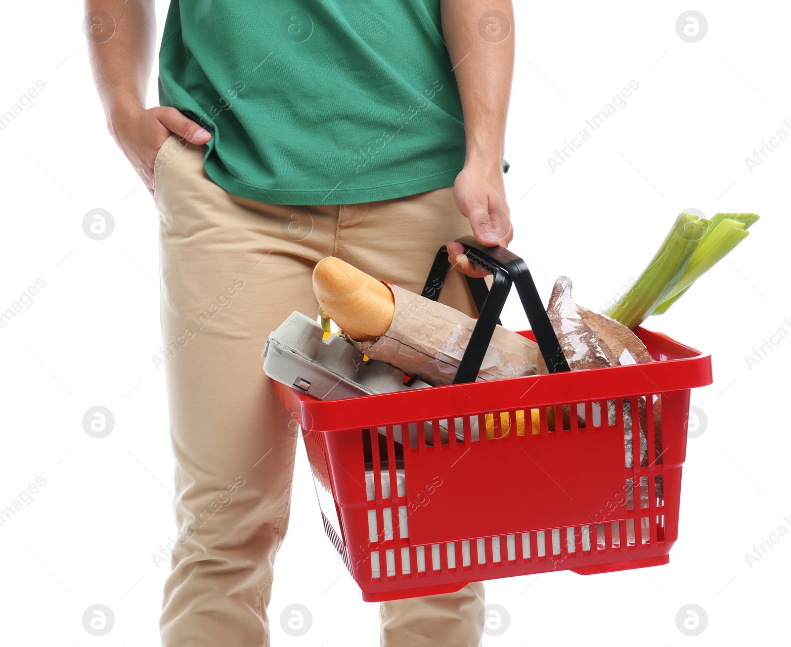 Photo of Young man with shopping basket full of products isolated on white, closeup