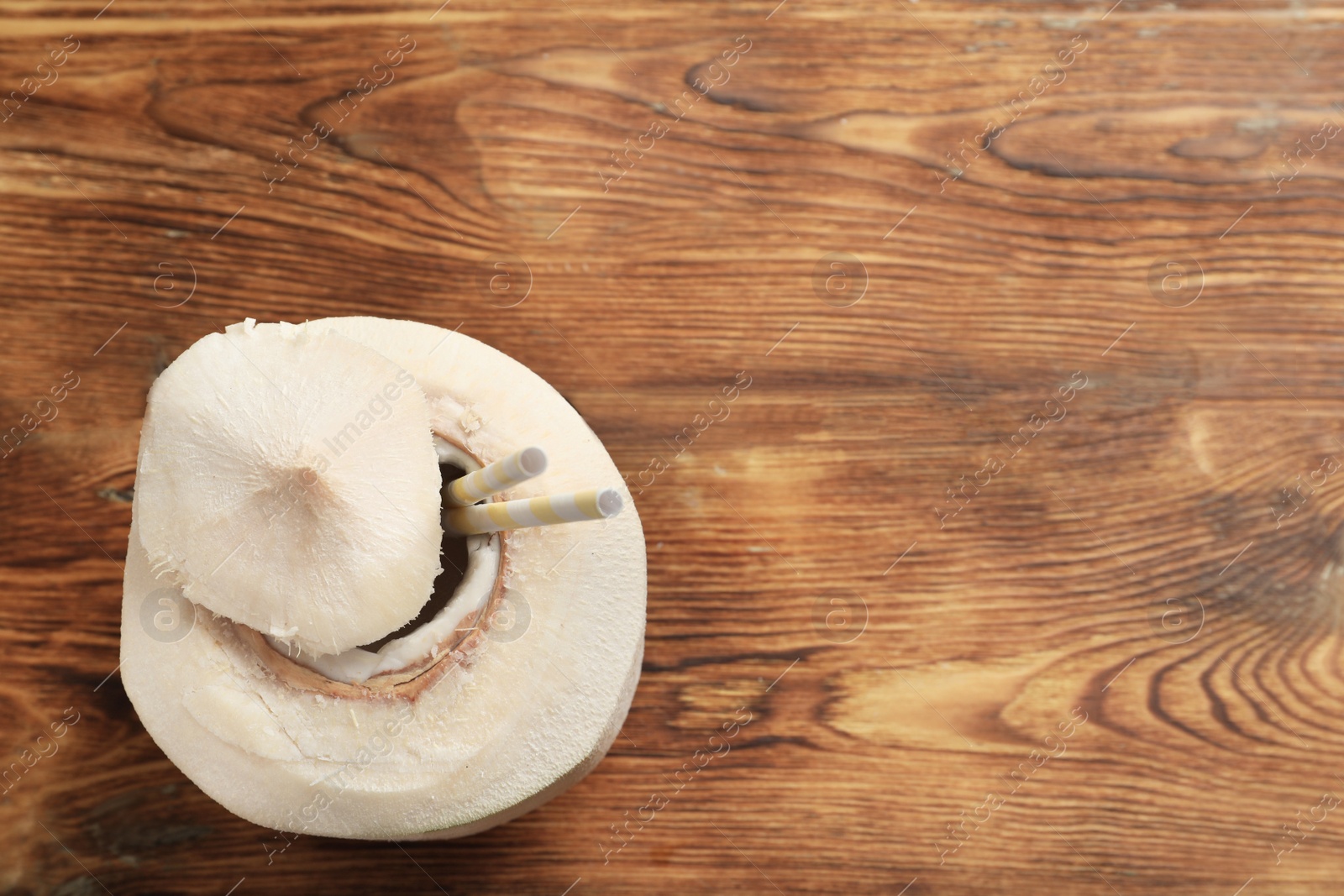 Photo of Fresh coconut drink in nut on wooden background