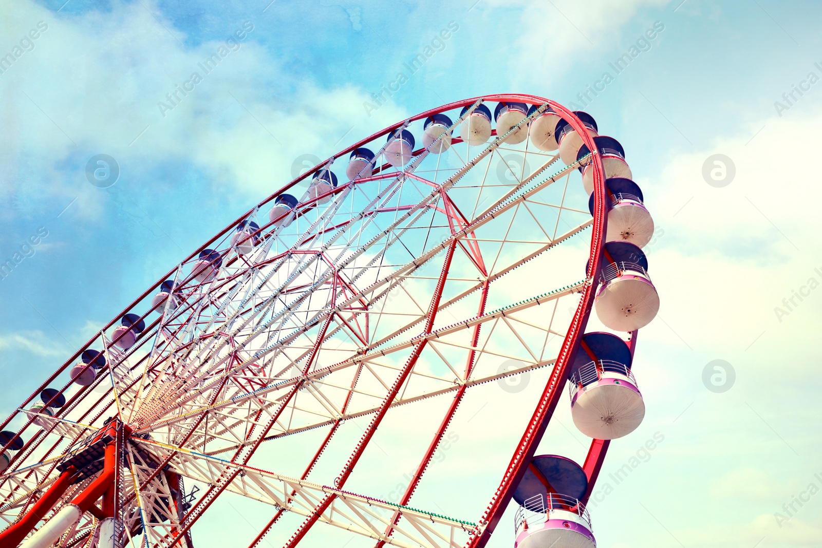 Image of Beautiful large Ferris wheel outdoors, low angle view