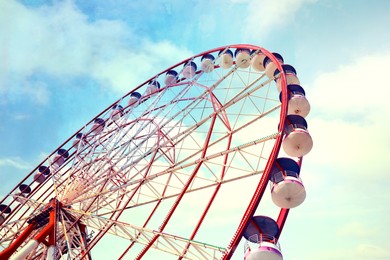 Image of Beautiful large Ferris wheel outdoors, low angle view