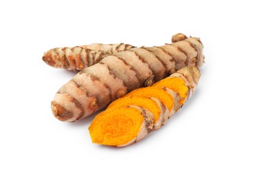 Whole and cut turmeric roots isolated on white