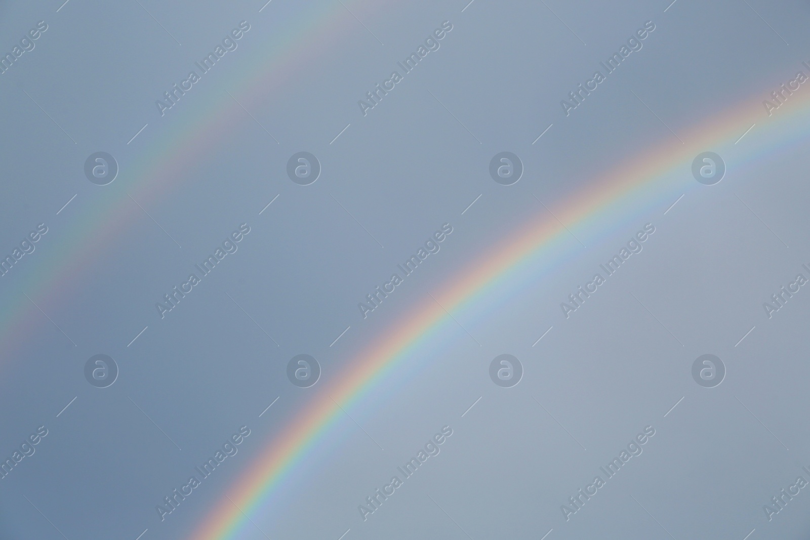 Photo of Beautiful view of double rainbow in sky on grey day