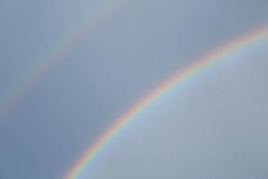 Photo of Beautiful view of double rainbow in sky on grey day
