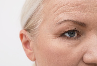 Closeup view of beautiful older woman on white background