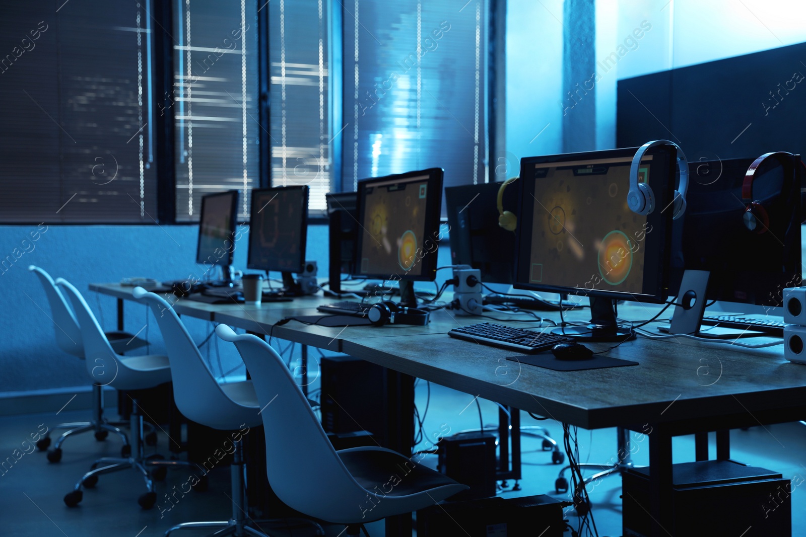 Photo of Internet cafe interior with modern computers. Video game tournament