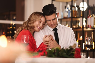 Lovely couple having romantic dinner on Valentine's day in restaurant