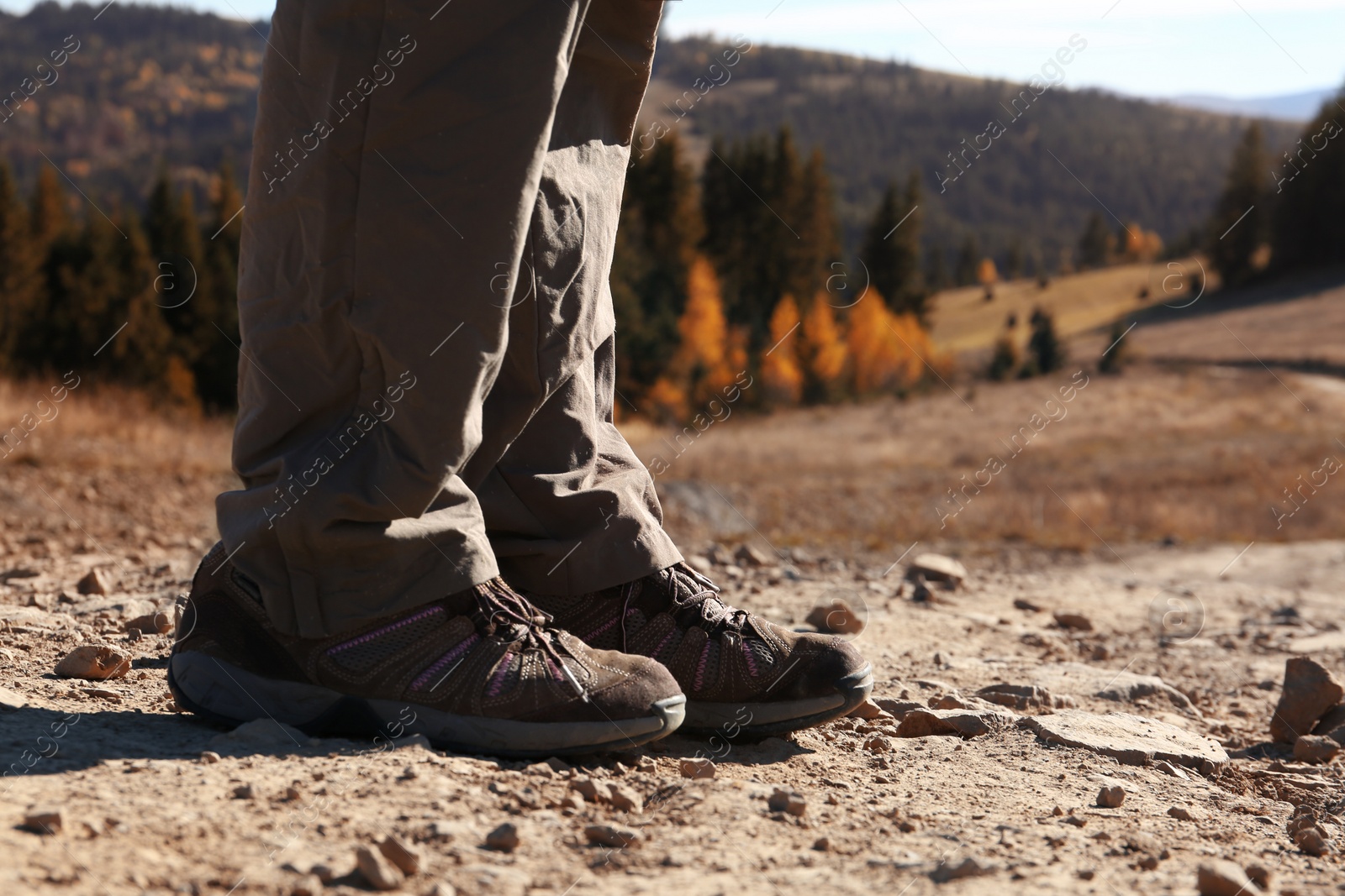 Photo of Female traveler standing on ground in mountains