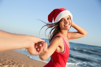Lovely couple with Santa hat on beach. Christmas vacation