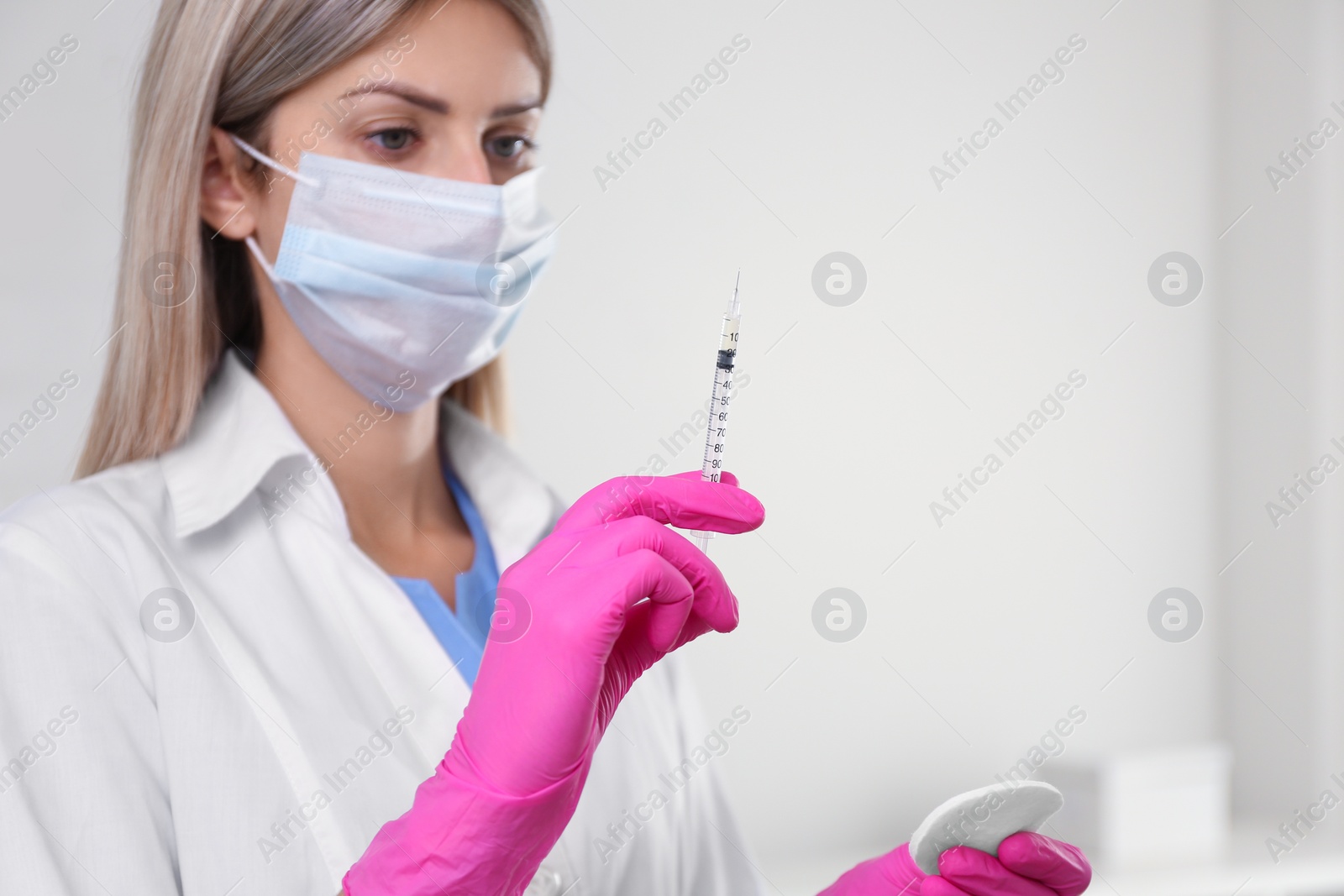 Photo of Doctor holding syringe with vaccine in hospital