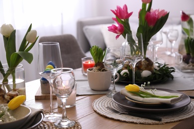 Beautiful Easter table setting with beautiful flowers indoors