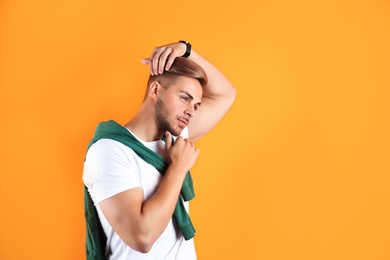 Photo of Young man with trendy hairstyle on color background