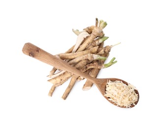 Photo of Spoon with grated horseradish and roots isolated on white, top view