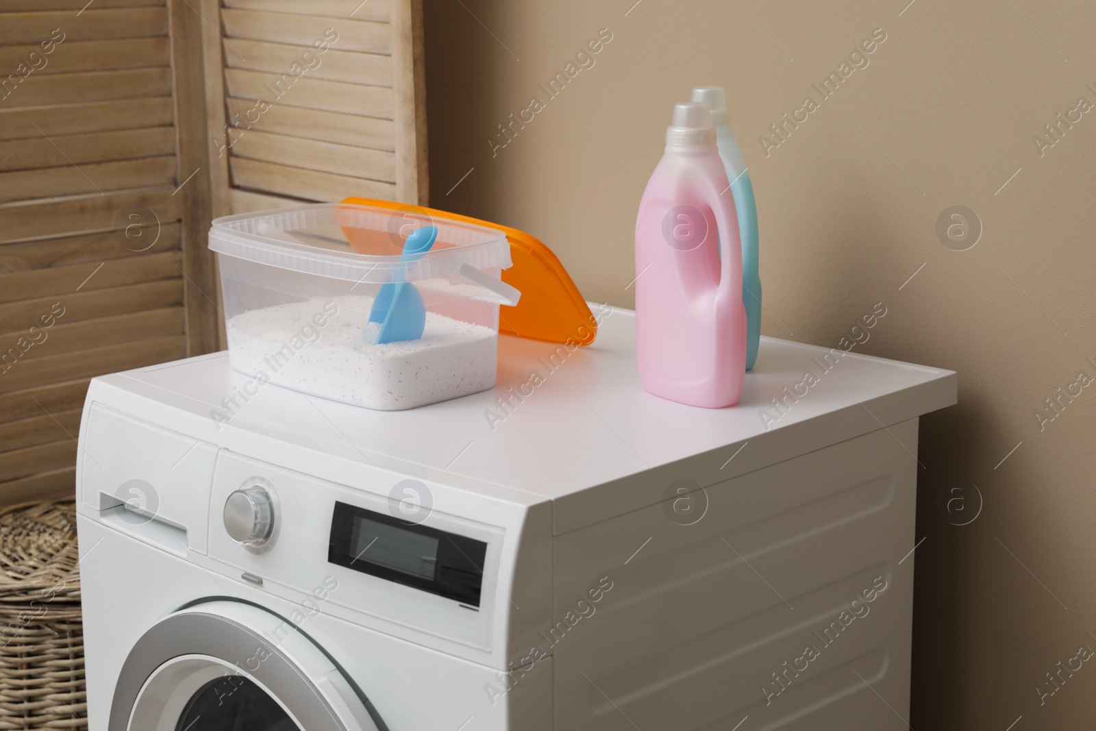 Photo of Laundry detergents on washing machine in room