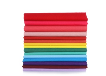 Photo of Pile of colorful t-shirts on white background