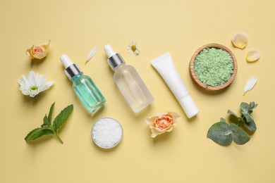 Photo of Flat lay composition with cosmetic serum on pale yellow background