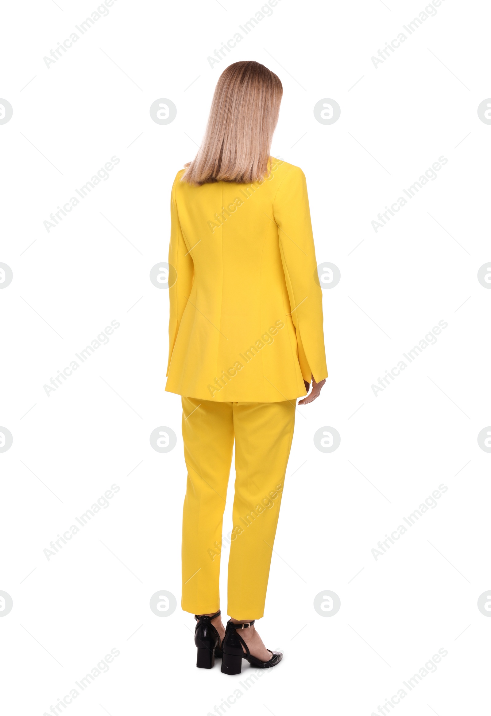 Photo of Businesswoman in suit standing on white background, back view