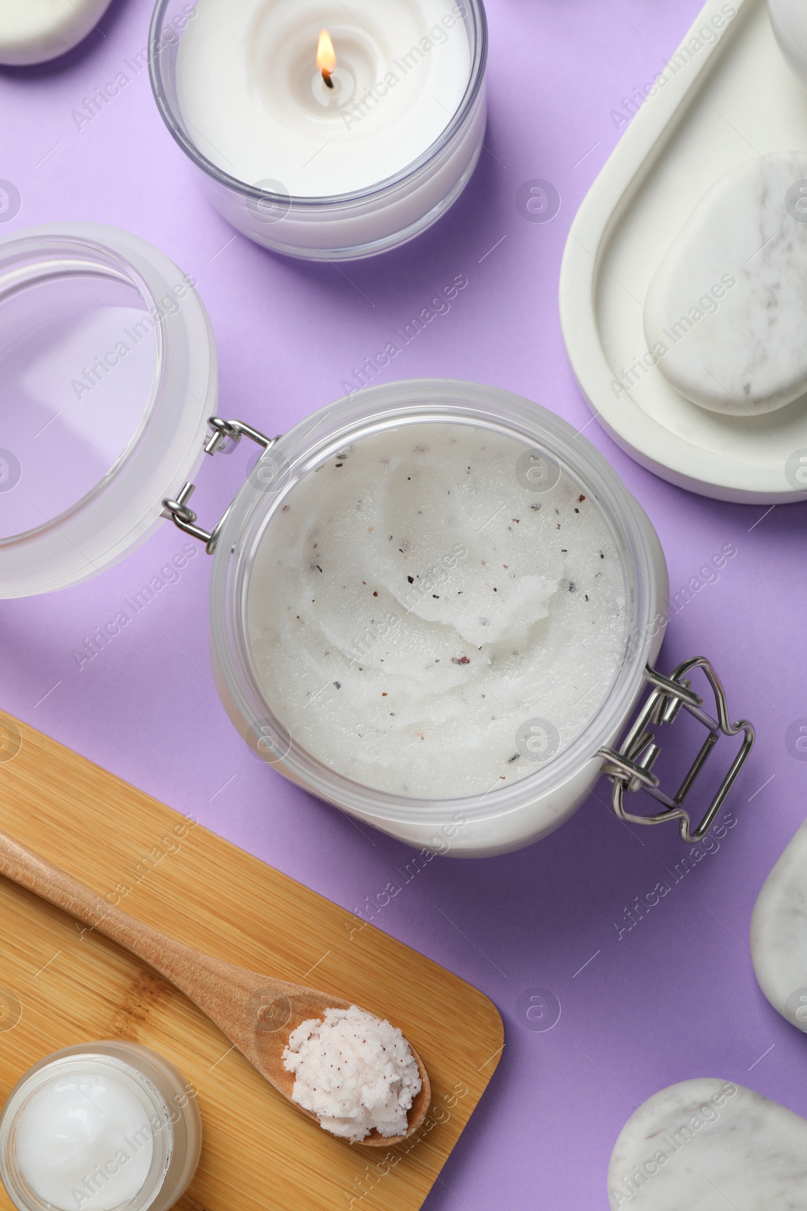 Photo of Flat lay composition with body scrub on violet background