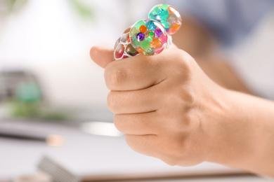 Woman squeezing colorful slime, closeup. Antistress toy