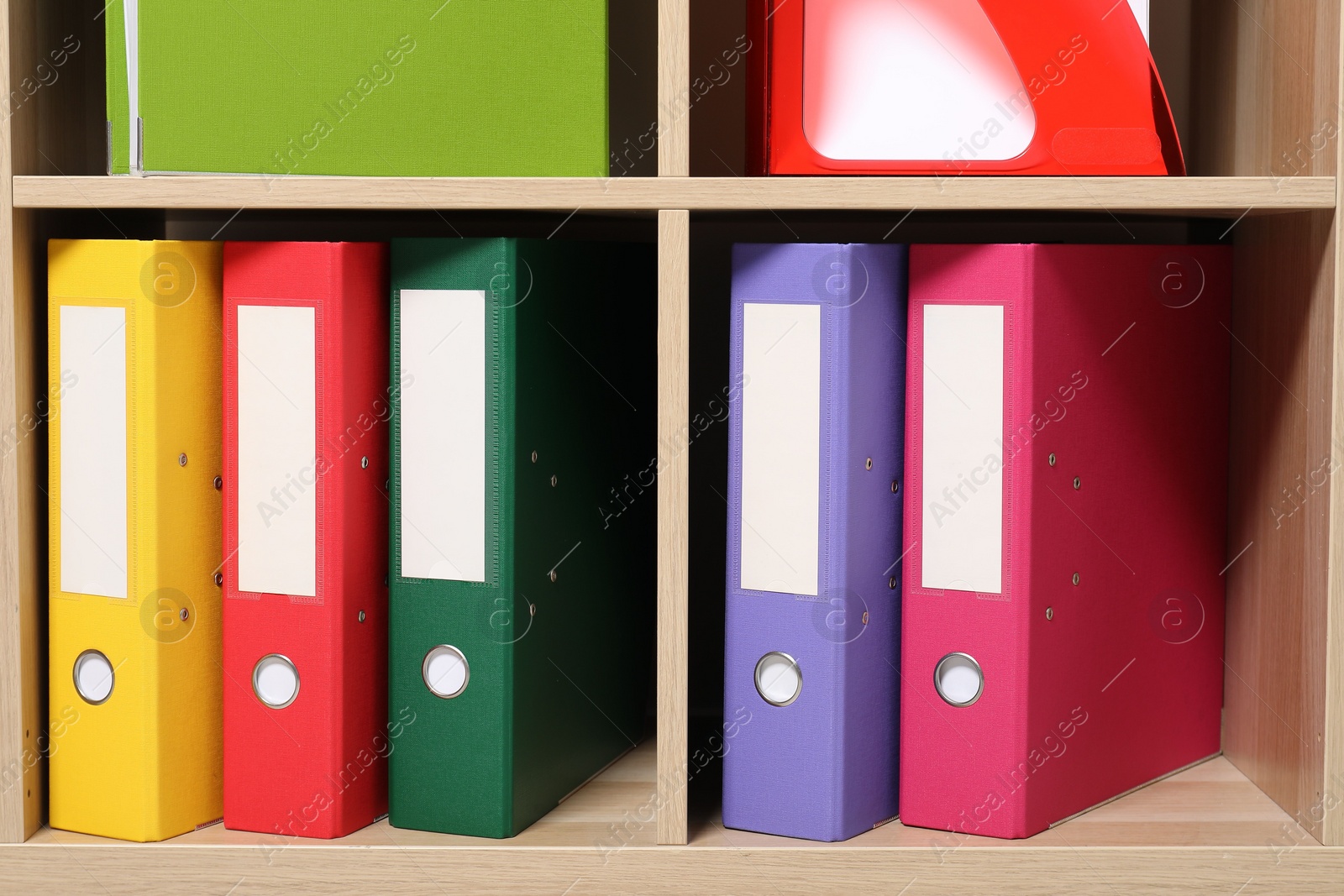 Photo of Colorful binder office folders on shelving unit