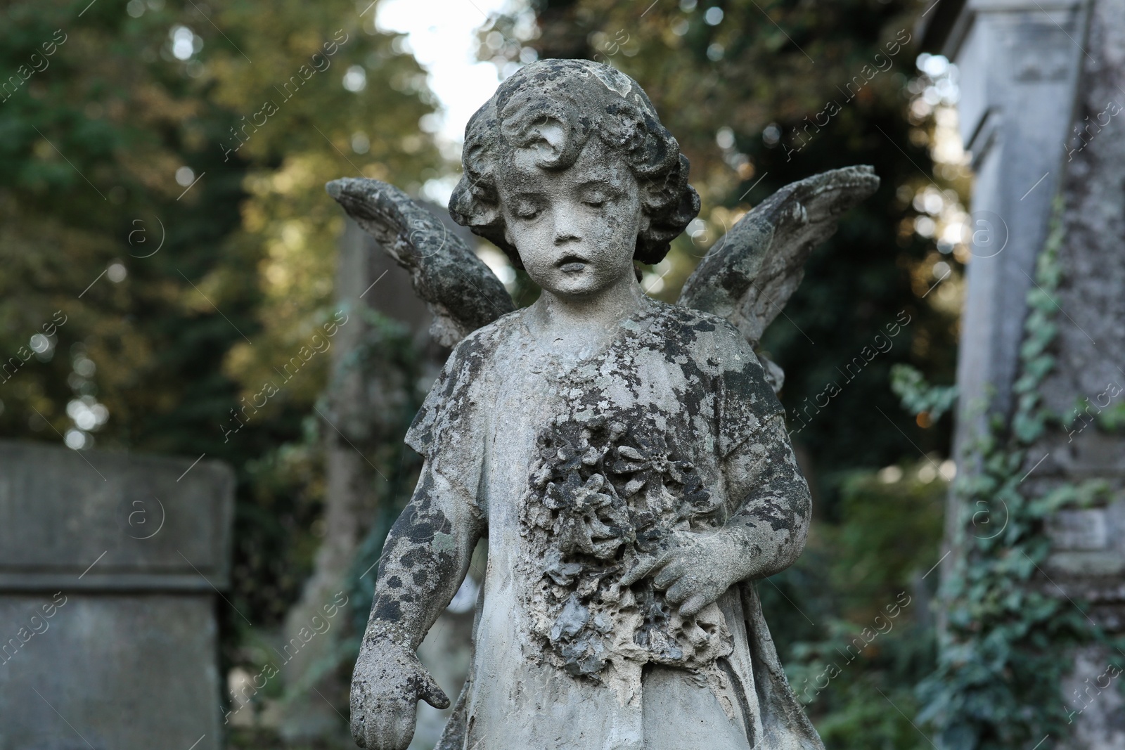 Photo of Beautiful statue of angel at cemetery. Religious symbol